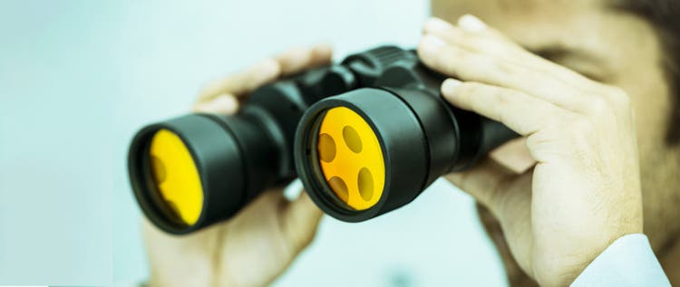 A person looking through binoculars
