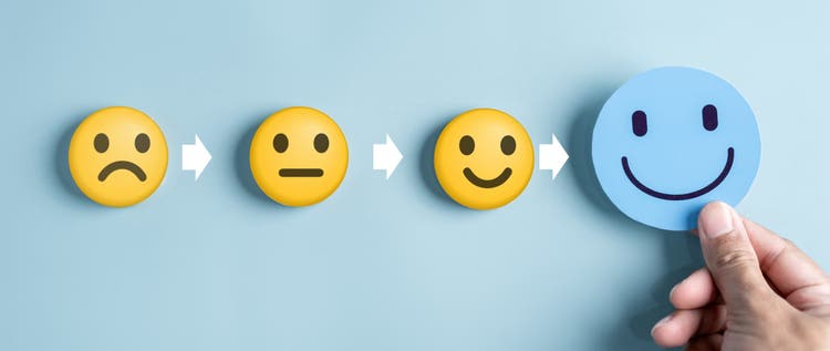 Hand holding blue happy smile face for medical care concept. mental health positive thinking. Refresh energy and brain boost.