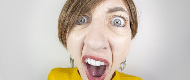 A fisheye image of a middle aged woman with short brown hair