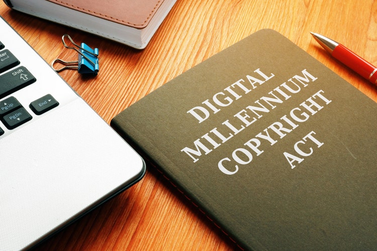 DMCA Digital Millennium Copyright Act and laptop.