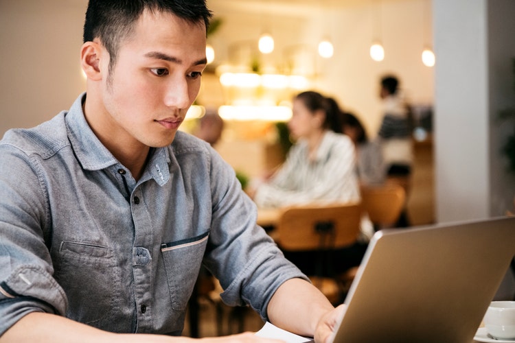 Professional businessman working on computer, freelance work, portability, digital nomad