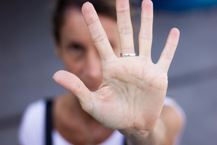 Palm of white hand of anonymous woman wide open. Violence against women social criticism concept