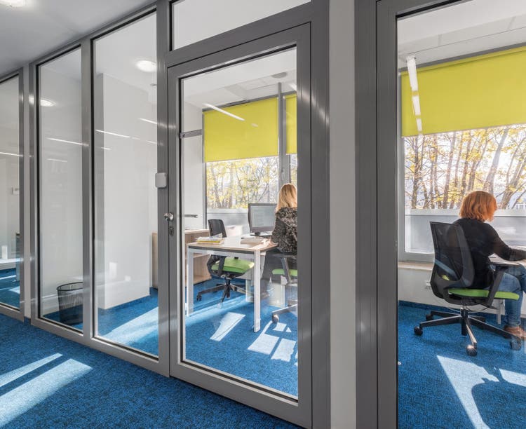 Modern and light office interior with glass wall